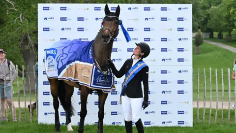 Badminton Horse Trials Caroline Powell from the New Zealand team at the winners stand with her brown bay horse Greenacres Special Cavalier looking rather pleased with himself.