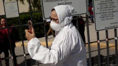 Reuters Susana Prieto, a lawyer and labour activist, is seen outside of a factory during a protest