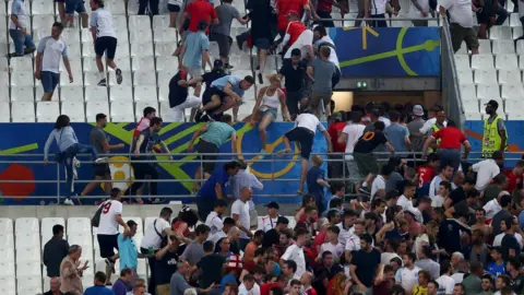 Getty Images England fans fleeing stadium