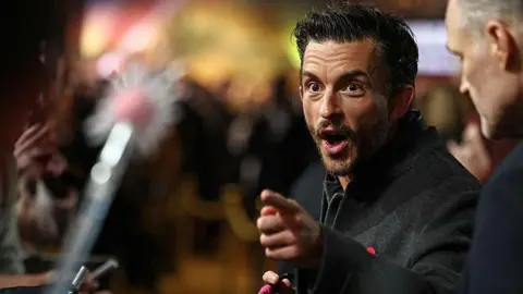 Getty Images British actor Jonathan Bailey speaks with fans as he attends the European premiere of the film 