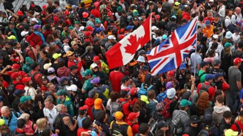 Fans carry a Canadian and A British flag during the 2023 Canadian Grand Prix 