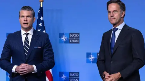 Reuters US defence secretary Pete Hesgeth stands next to Nato secretary general Mark Rutte.