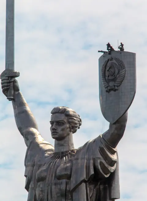 Future Publishing via Getty Images Workers prepare to dismantle the state emblem of the Soviet Union from the shield of the Motherland Monument in Kyiv as it will be replaced by the Trident - Ukraine's coat of arms. Photo: July 2023