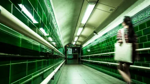 Getty Images Blurred image of a woman in a deserted subway