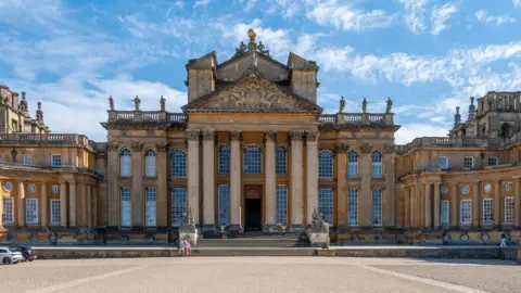 The grand entrance steps of Blenheim Palace under a clear sky.