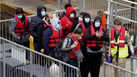 PA Media Migrants arriving at Dover