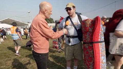 BBC reporter Colin Paterson speaks to a festival-goer