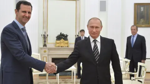 Reuters Russian President Vladimir Putin shakes hands with Syrian President Bashar al-Assad at the Kremlin in Moscow (20 October 2015)