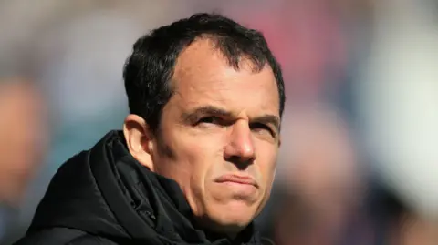 Sunderland head coach Regis Le Bris slightly squinting on a sunny afternoon