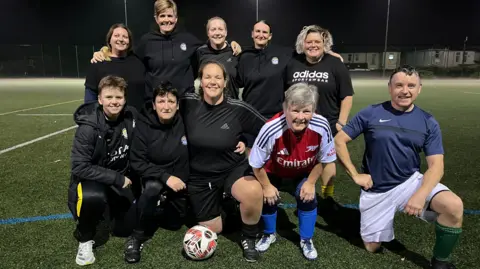 Caerphilly Castle walking football team pose for a group photograph