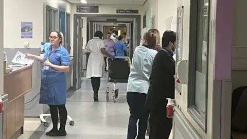 The busy corridor in the medical assessment unit at the Royal Derby Hospital showing several staff