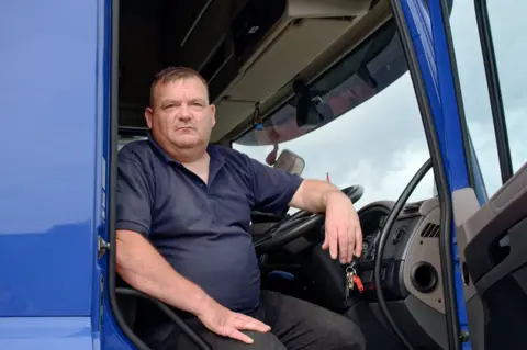 Graham Barnes sat in the cab of his blue lorry