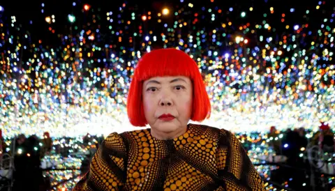 Reuters Japanese artist Yayoi Kusama poses for a photograph inside her Infinity Mirrored Room installation titled "The Souls of Millions of Light Years Away" during a media preview of her new exhibition at the David Zwirner gallery in New York, U.S.