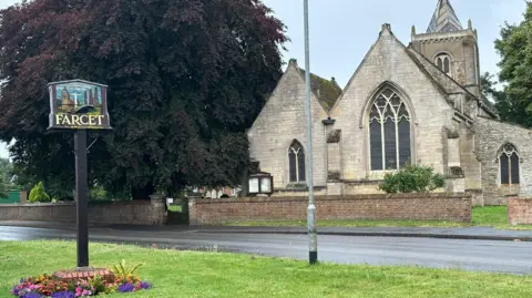 Shariqua Ahmed/BBC A church and village sign in Farcet