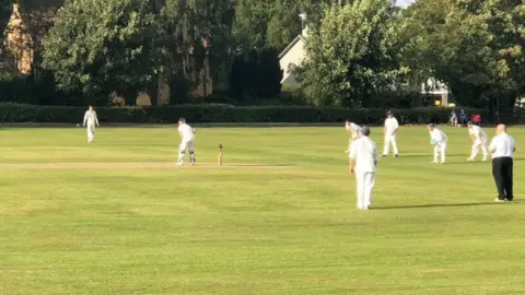 Ed Townend  People play cricket on a field