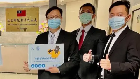 The Taiwanese Representative Office in Lithuania Officials pose for a picture outside the Taiwanese Representative Office in Lithuania