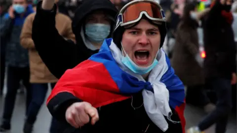 Reuters A man wearing a Russian flag shiuts during a rally in support of jailed Russian opposition leader Alexei Navalny in Saint Petersburg