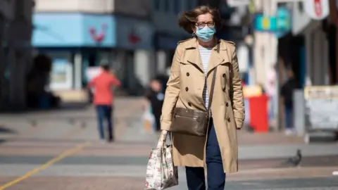 Getty Images Woman wearing a face mask in Merthyr Tydfil