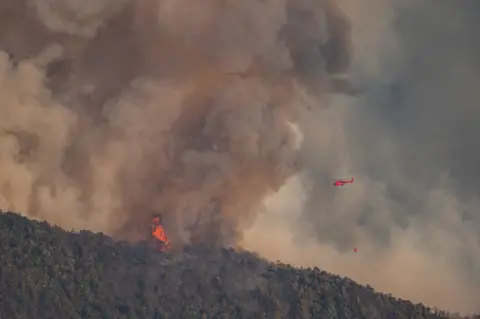 NurPhoto/Getty Images A water bomber helicopter is mobilized on a major forest fire near the town of Romeyer in south-east France.