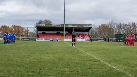 Richard Minshull FC Nomads (blue) held a minute's silence for their former president