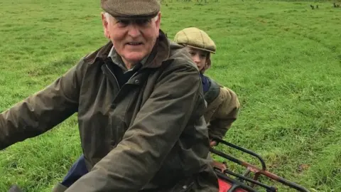 Family Handout Francis Collingborn on a tractor with his grandson Maxi