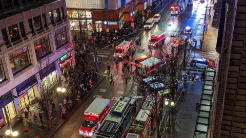 NIKESH PAREKH/AFP Police at the scene of a shooting which left one dead and seven injured on Pine street in central Seattle, Washington State. 22 Jan 2020