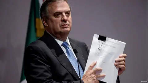 Reuters Mexican Foreign Minister Marcelo Ebrard holds documents during a news conference announcing a lawsuit against American gun makers