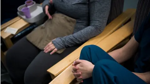 The Washington Post via Getty Images A doula speaks with a patient after an abortion