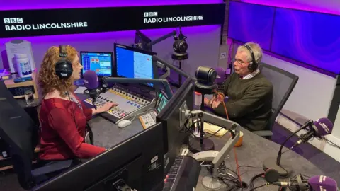 BBC Radio Lincolnshire presenter Frances Finn in the radio studio with Martin Hill