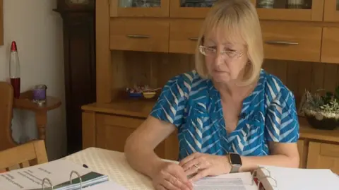 Karen sat at her desk looking over her paperwork for her home