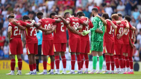 Liverpool players observe a minute's silence for Diogo Jota and Andre Silva ahead of friendly match at Preston