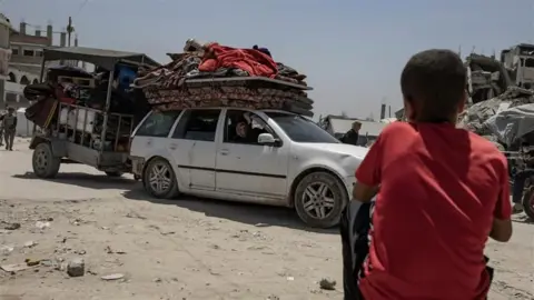 Displaced Palestinians flee their homes in the town of Beit Lahia, north of Gaza City, amid ongoing Israeli military operations and continuous evacuation orders across the Gaza Strip, in the northern part of the territory