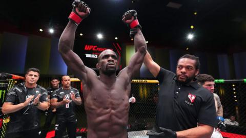 Themba Gorimbo has his arm raised by referee Herb Dean after beating Pete Rodriguez