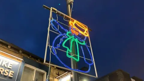 Tom Ingall/BBC More festive lights on a lamppost in the shape of a snowman. 