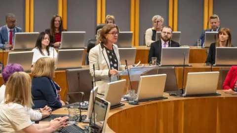 Senedd Cymru Eluned Morgan stood addressing the Senedd after the vote to confirm her as first minister