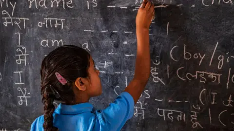 Indian schoolgirl in classroom, English language class, Rajasthan, India, 2018