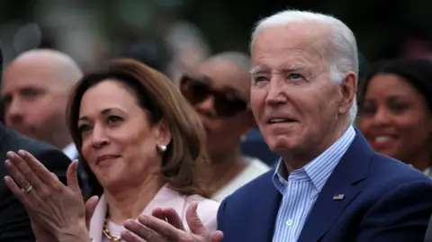 Reuters  U.S. President Joe Biden claps hands next to U.S. Vice-President Kamala Harris while hosting a Juneteenth concert on the South Lawn at the White House in Washington, D.C., U.S. June 10, 2024.