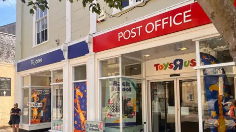 A double shop front with TG Jones on the left and Post Office on the right