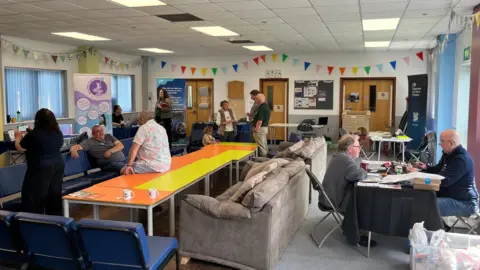 A room of people, chatting in small groups