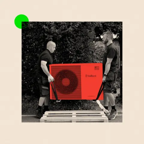 BBC A treated image of two men on either side holding a heat pump