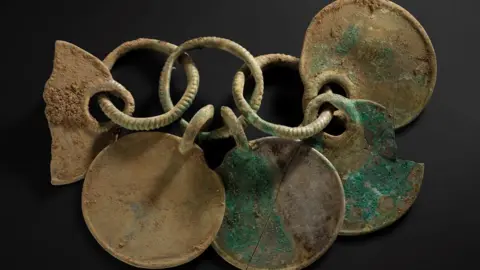 A bronze rattle pendant from the Peebles hoard made up of interlinked circles and rings