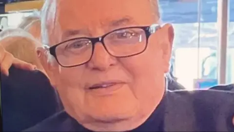 Police Scotland David Gow has short, white hair and is wearing black glasses and a dark top.