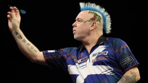 Peter Wright in Saltire shirt, throwing a dart