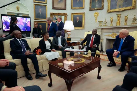 President of South Africa Cyril Ramaphosa (2nd-R) and US President Donald Trump (R) look on as a video plays in the Oval Office of the White House 