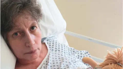 Sylvia Hubbard Jocelyn Ullmer lying in a hospital bed.