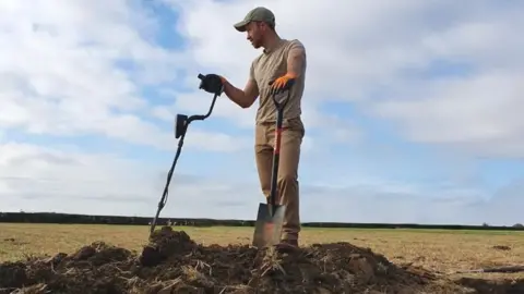 George Ridgway George Ridgway in a field with metal detector