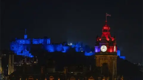 PA Media Edinburgh Castle and the Balmoral Clock seen at midnight on New Year's Eve