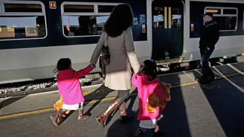 Getty Images passengers board train