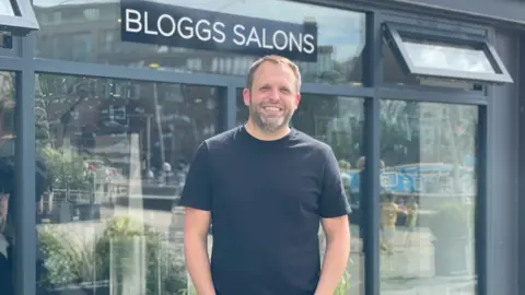 Bloggs Salons Joe Hemmings outside his salon