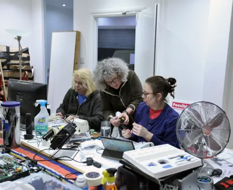 BBC Volunteers repair electrical items at the Fixing Factory in Camden, London